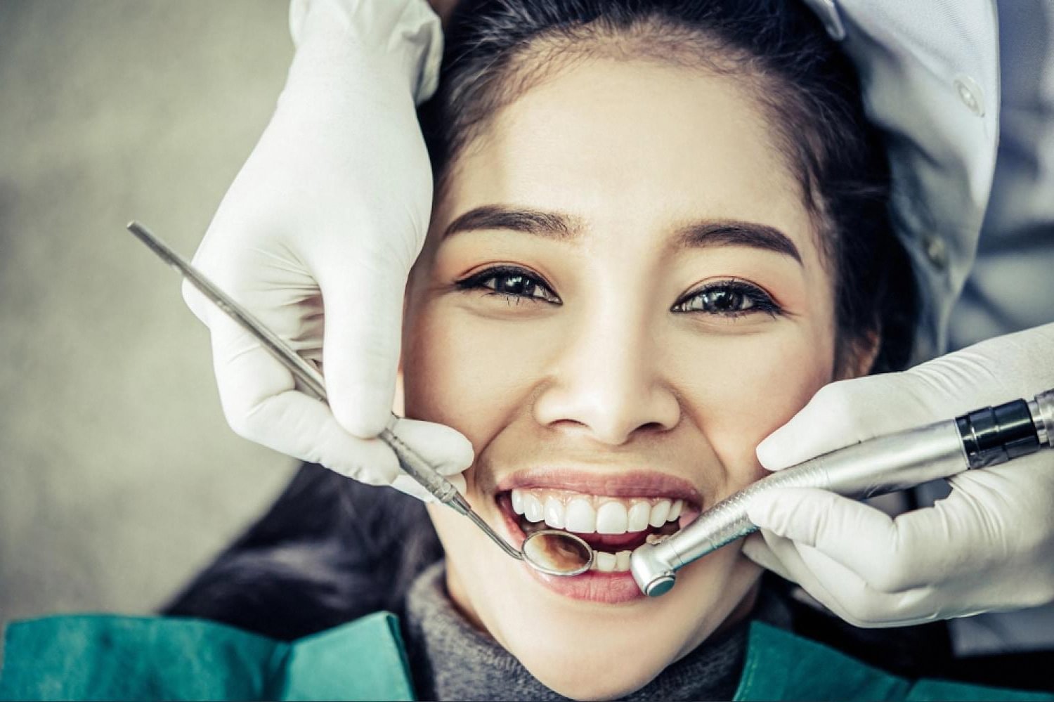 Dentist examining a patient's teeth with dental tools during an orthodontic consultation
